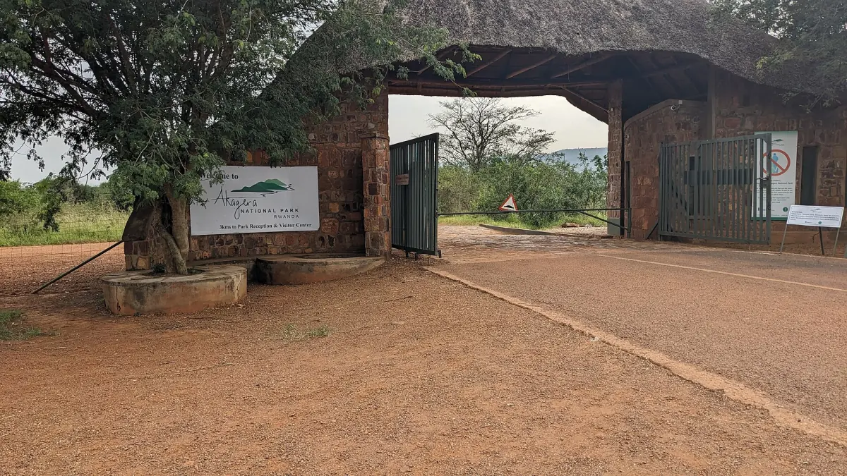 The brick entrance gate of the park on a dirt road